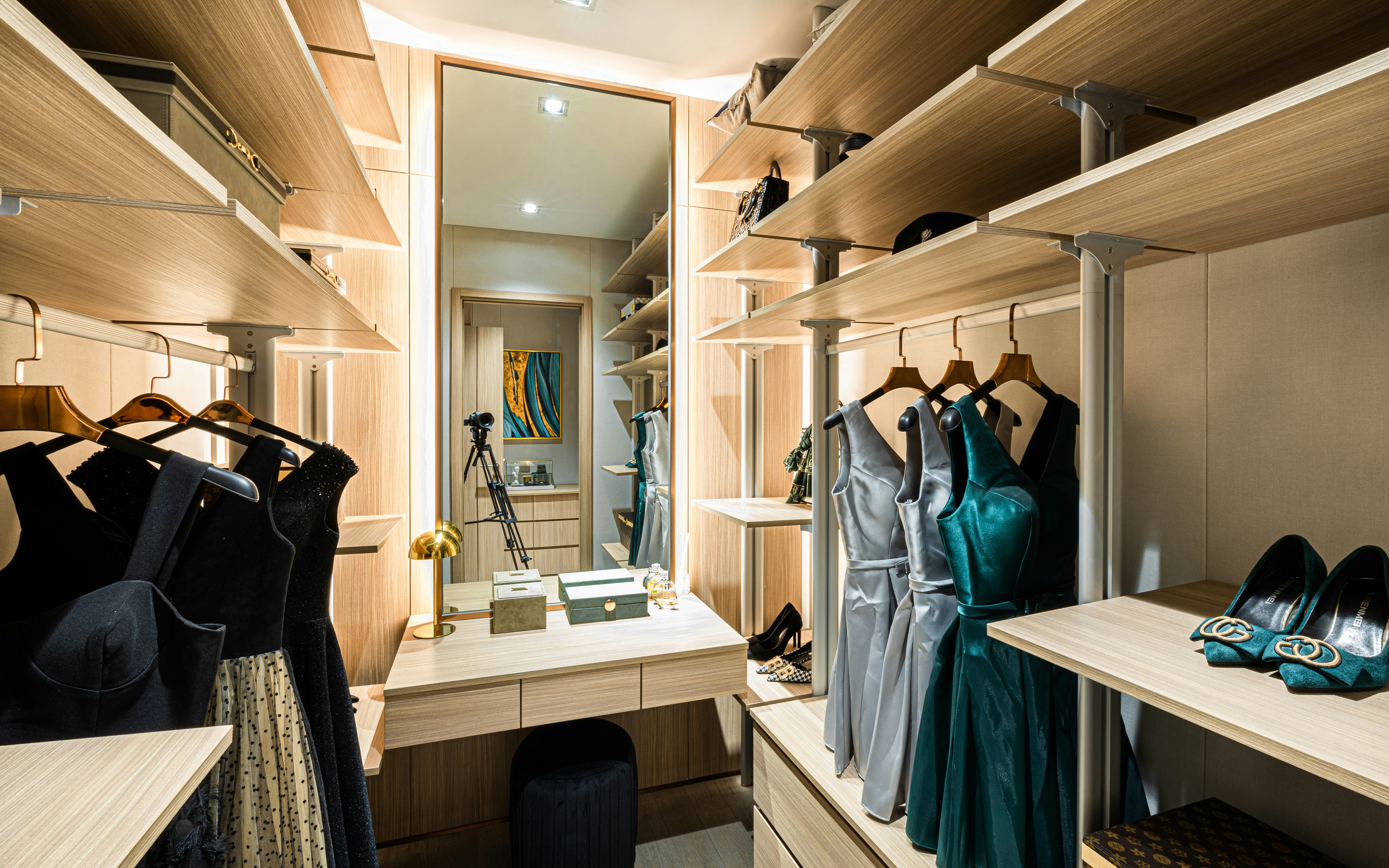 black leather jacket hanged on brown wooden cabinet